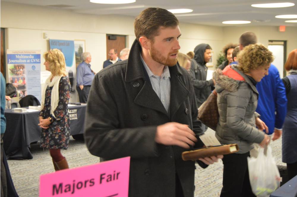 A student engaged in conversation at the Academic Major Fair.
